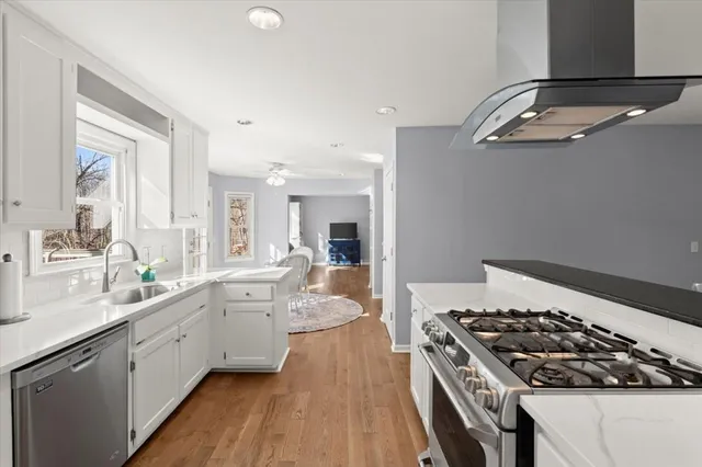 a kitchen with a stove a sink and a refrigerator