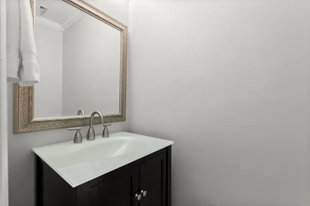 a bathroom with a sink vanity and a mirror