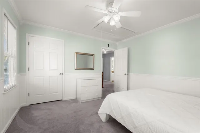 a spacious bedroom with a bed and a chandelier