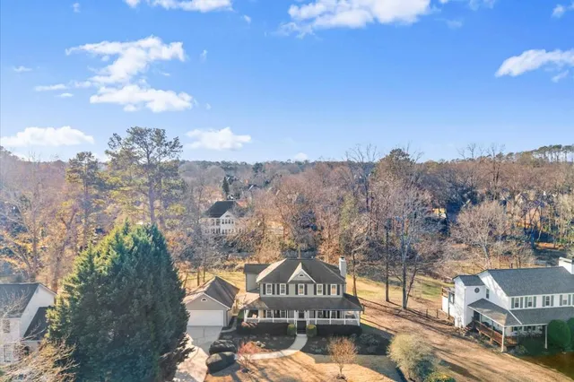a view of a house with a yard covered with snow in the background