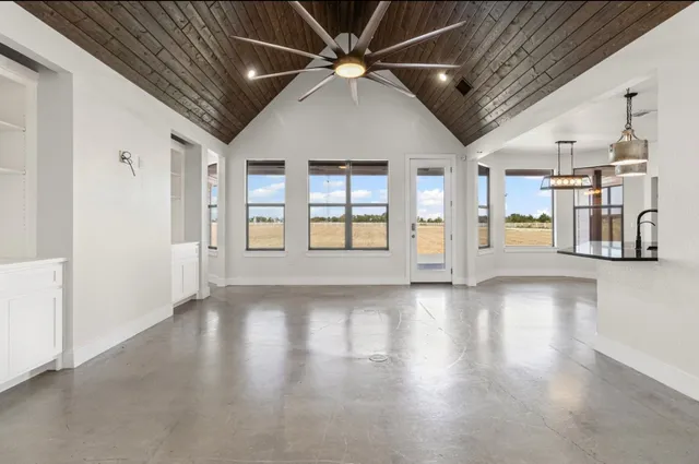 a view of a kitchen with a sink and a refrigerator
