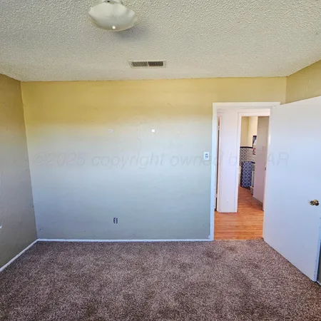 a spacious bathroom with a granite countertop toilet a sink and a mirror
