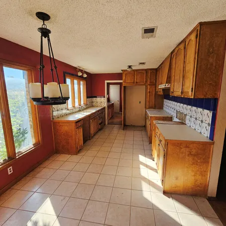 a kitchen with stainless steel appliances a sink stove and cabinets