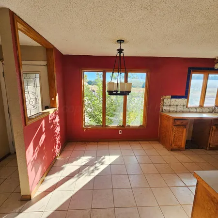 a view of a room with window and chandelier