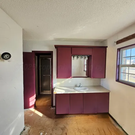 a bathroom with a granite countertop sink and mirror