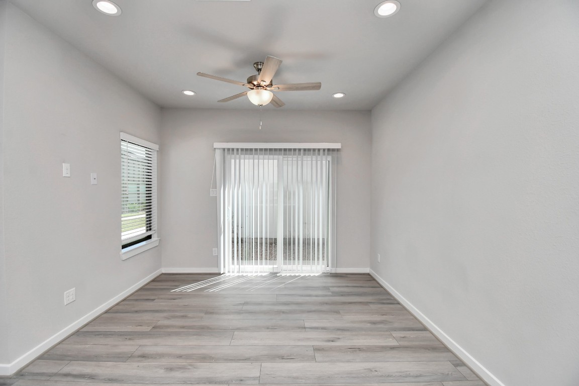23823 Cumberland Ridge Drive, Unit 515 Hockley, TX 77447 - Photo 11 of 29 a view of an empty room with wooden floor and a window
