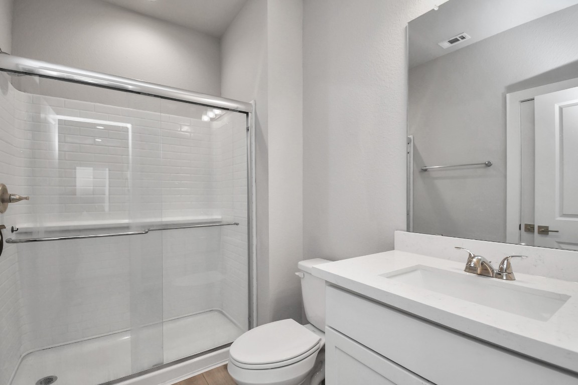 23823 Cumberland Ridge Drive, Unit 515 Hockley, TX 77447 - Photo 12 of 29 a bathroom with a granite countertop sink toilet and shower