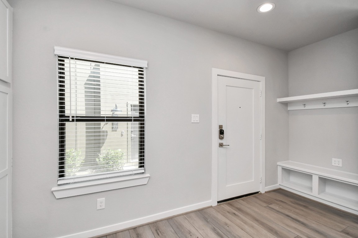 23823 Cumberland Ridge Drive, Unit 515 Hockley, TX 77447 - Photo 10 of 29 an empty room with wooden floor and windows