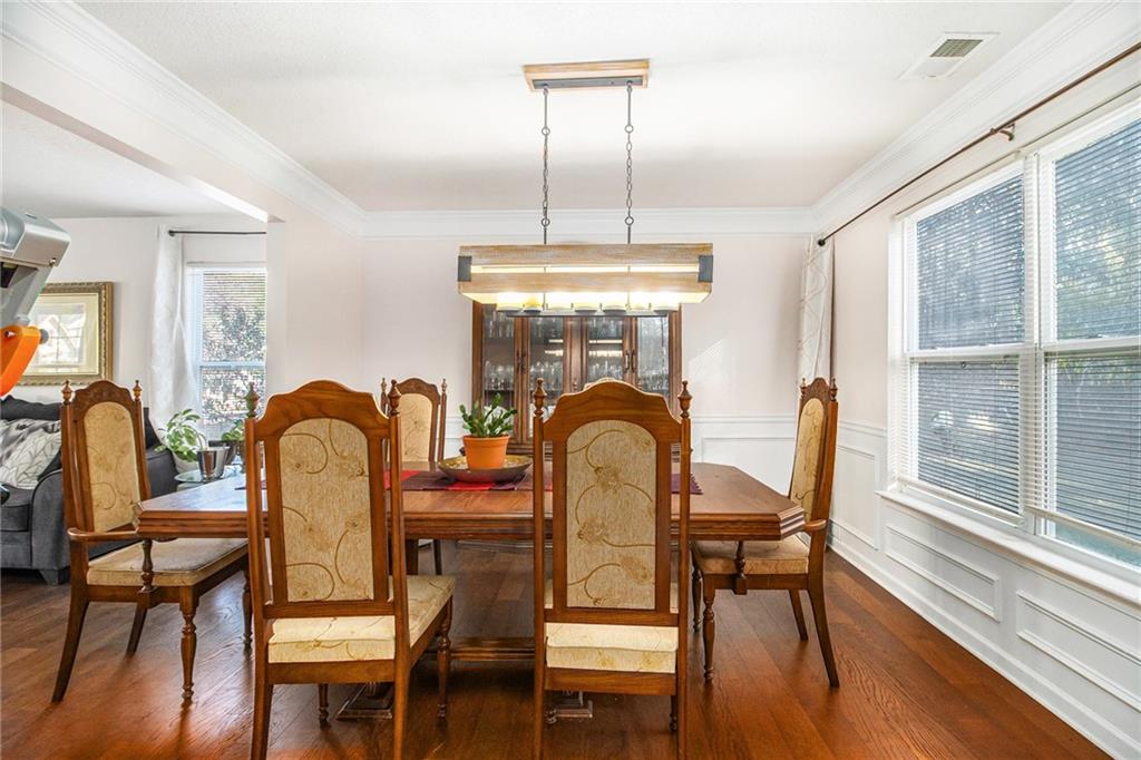 5139 Miller Woods Trail Decatur, GA 30035 - Photo 13 of 36 a dining room with furniture a chandelier and wooden floor