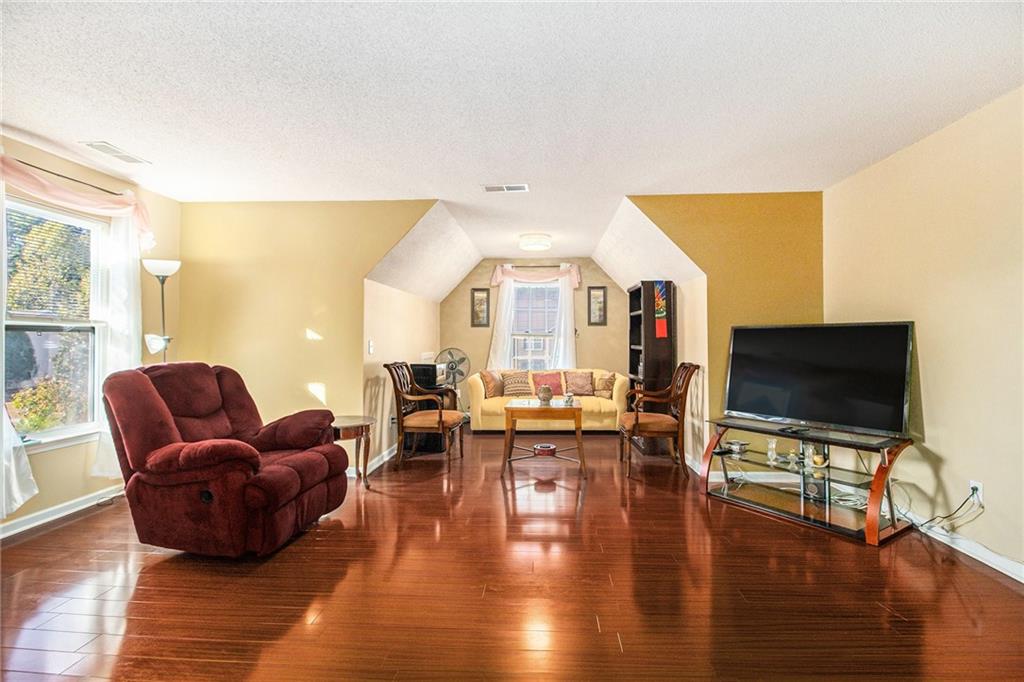 5139 Miller Woods Trail Decatur, GA 30035 - Photo 19 of 36 a living room with furniture flat screen tv and wooden floor