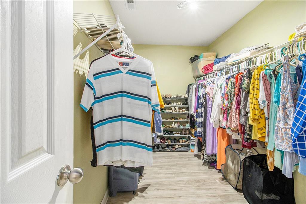 5139 Miller Woods Trail Decatur, GA 30035 - Photo 25 of 36 a view of walk in closet with clothes and shoes