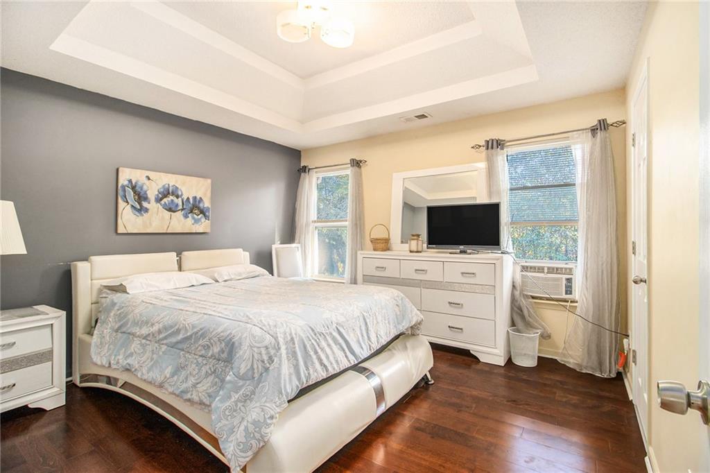 5139 Miller Woods Trail Decatur, GA 30035 - Photo 26 of 36 a bedroom with a large bed and a flat tv screen on dresser