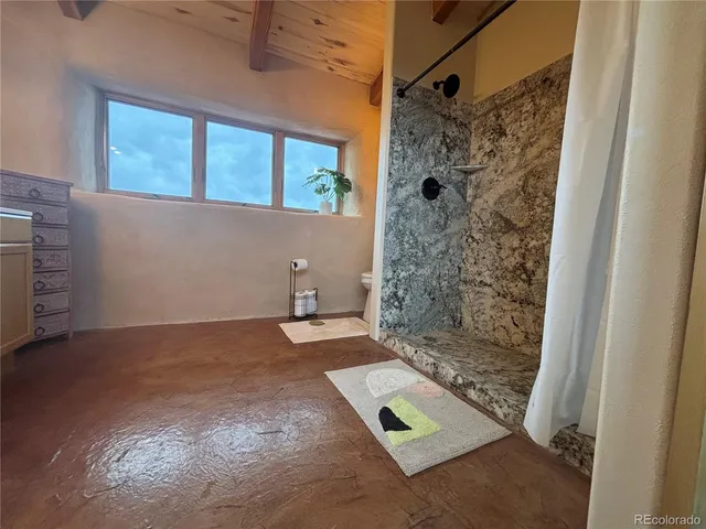 a bathroom with a sink mirror and window