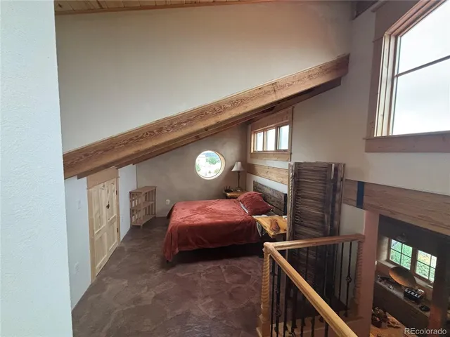 a bed room with two bed and a window