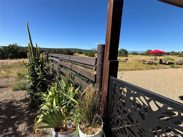 a view of hallway with stairs and wooden floor