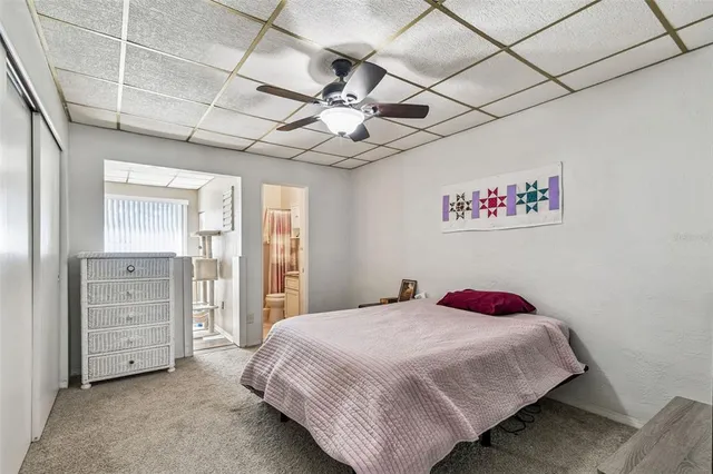a bedroom with a large bed and a flat screen tv