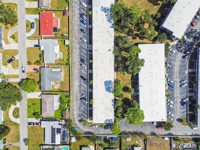 a view of a tennis ground with large trees