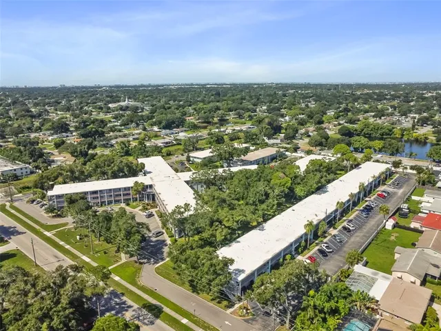 a view of a house with a yard table and chairs