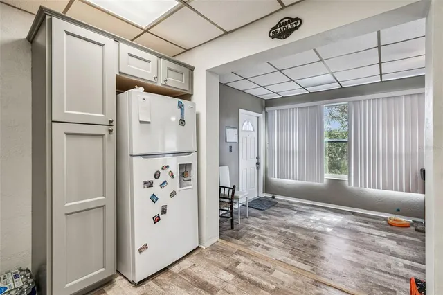 a kitchen with stainless steel appliances granite countertop a sink stove refrigerator and cabinets
