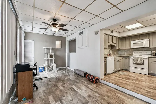 a living room with furniture a ceiling fan and a rug