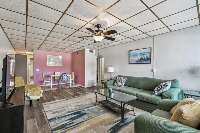 a living room with furniture and a chandelier