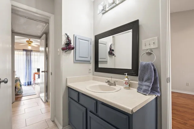 a bathroom with a sink vanity and mirror