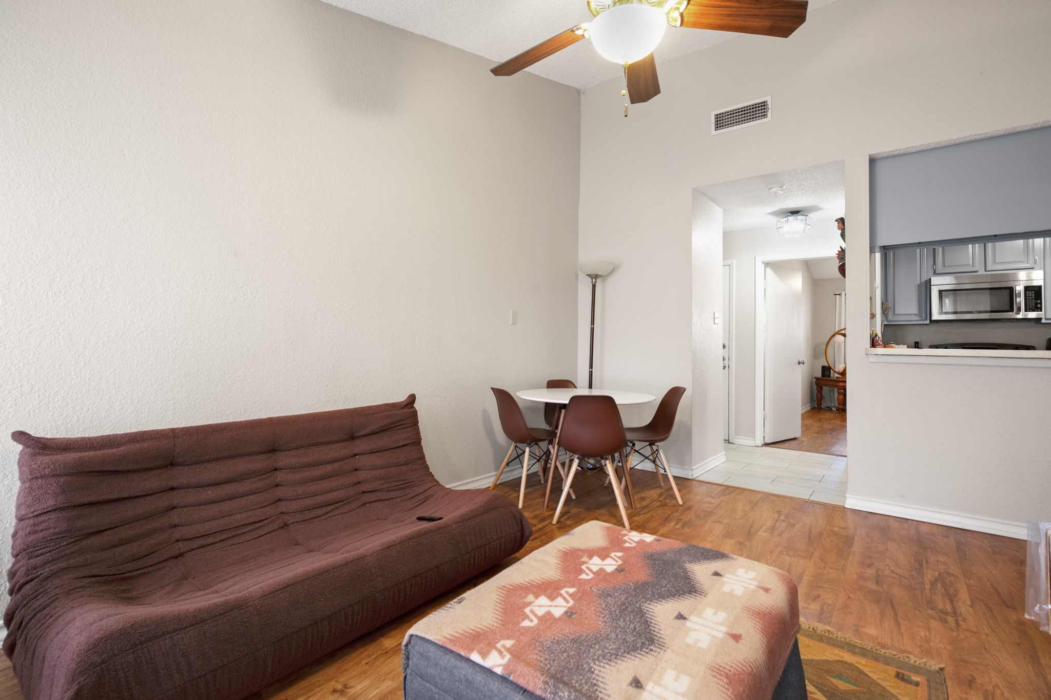 806 West 24th Street, Unit 323 Austin, TX 78705 - Photo 2 of 16 a living room with furniture and a wooden floor