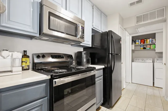 a kitchen with stainless steel appliances a stove a microwave and a refrigerator