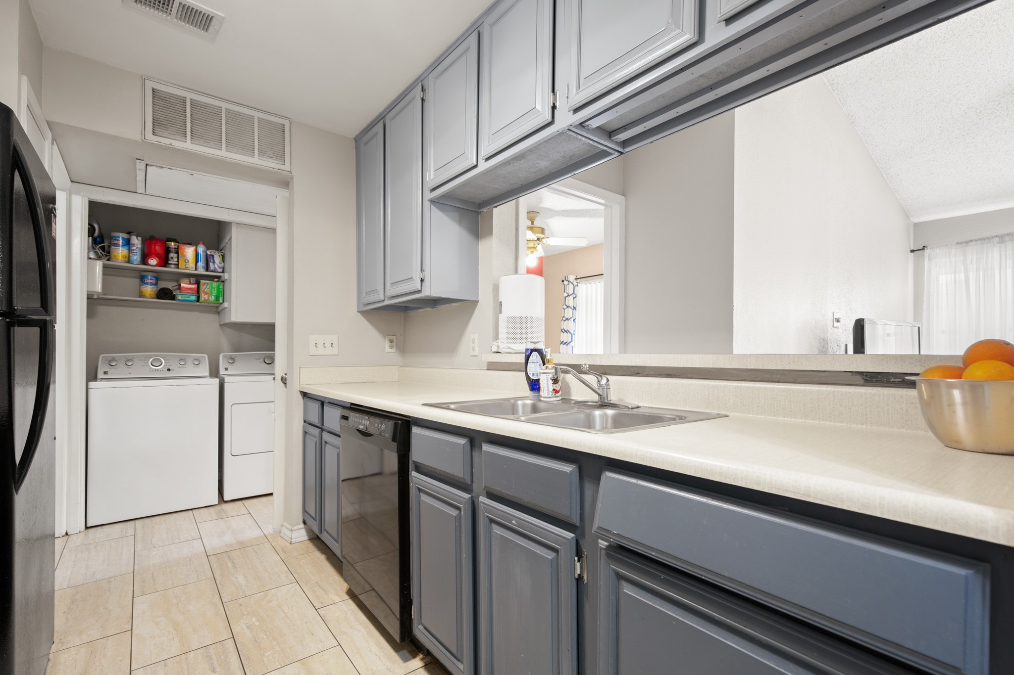 806 West 24th Street, Unit 323 Austin, TX 78705 - Photo 10 of 16 a kitchen with a sink and a refrigerator