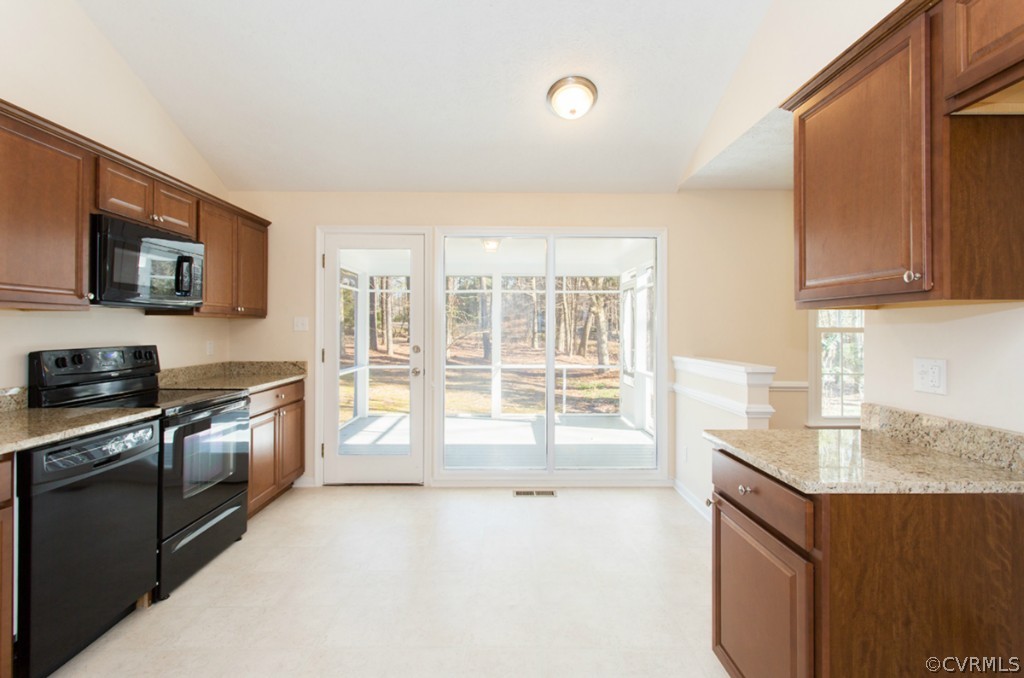 3541 Markey Road Midlothian, VA 23112 - Photo 3 of 24 a kitchen with granite countertop a stove top oven a sink a counter space and cabinets
