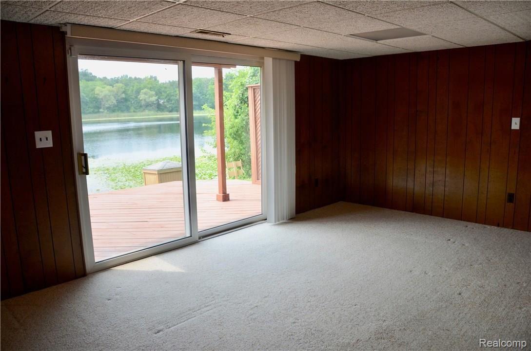 6681 Andersonville Road, Unit 28 Clarkston, MI 48346 - Photo 17 of 22 Another view of Lower Level Family Room looking out to spacious deck and just stepsfrom your own private dock.