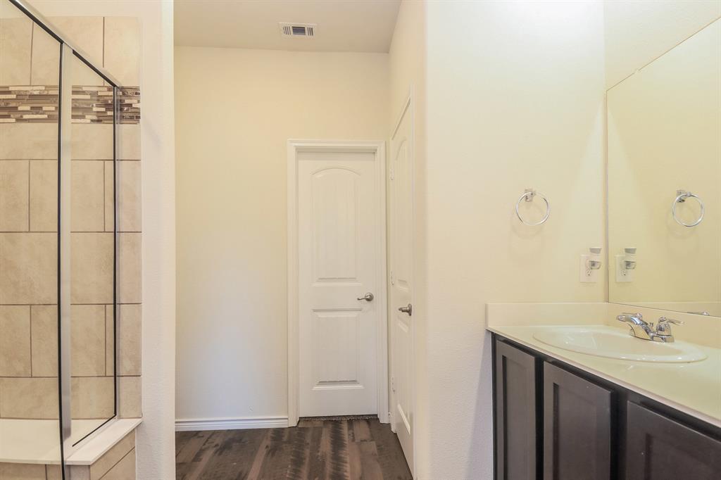 574 Kara Drive Fate, TX 75087 - Photo 12 of 15 a bathroom with a sink and shower