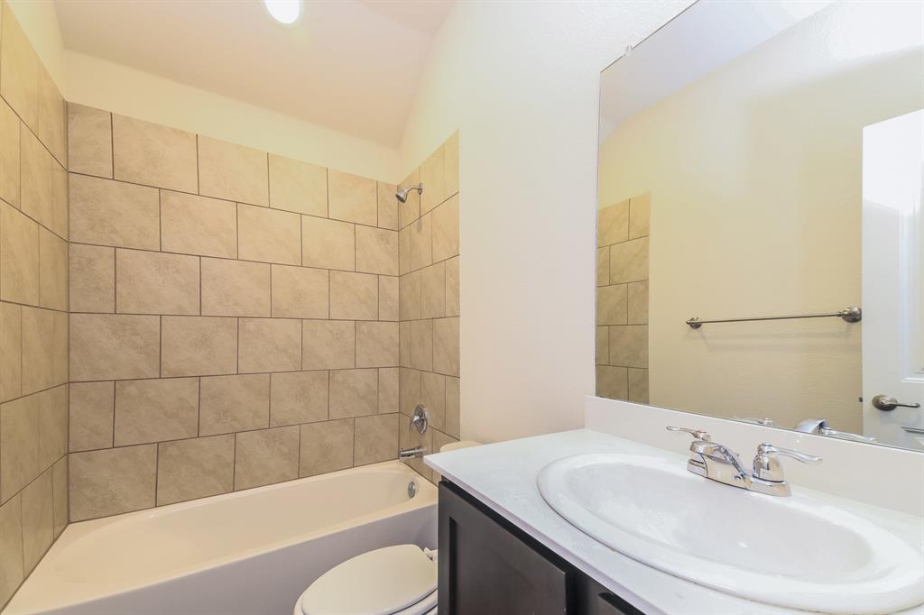 574 Kara Drive Fate, TX 75087 - Photo 14 of 15 a bathroom with a sink a toilet and bathtub