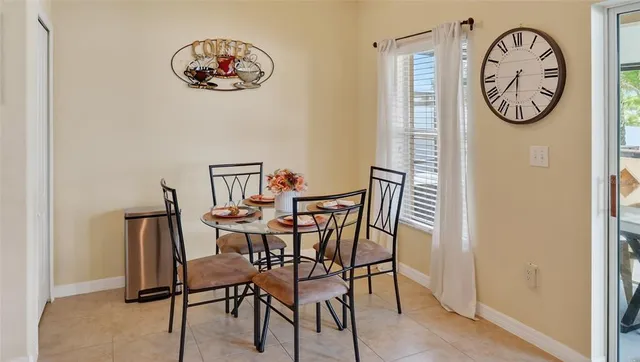 a view of a dining area with furniture and a wall painting