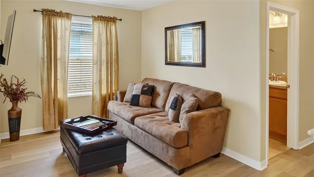 a bed sitting in a bedroom next to a window