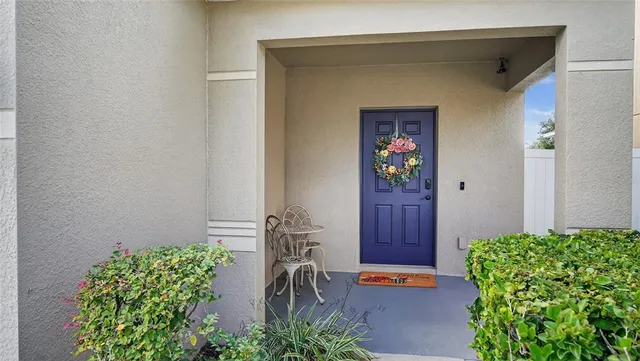 a front view of a house with potted plants
