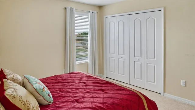 a bedroom with a bed and window