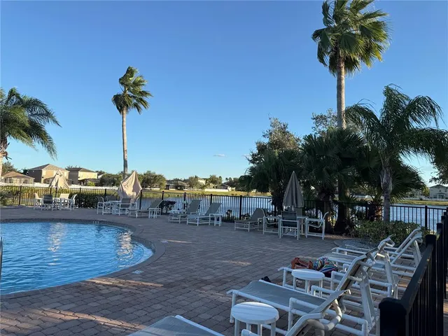 a view of a swimming pool and lounge chair