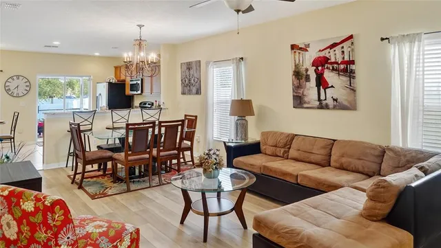 a living room with furniture and a chandelier