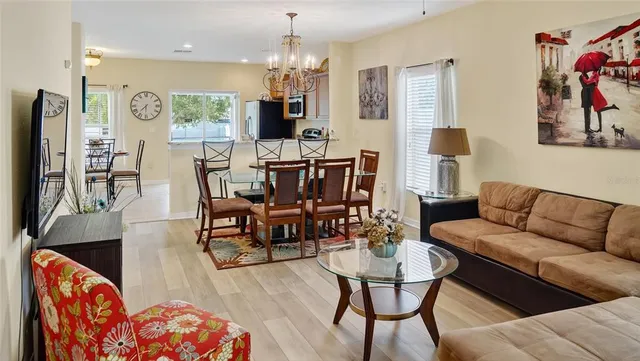 a living room with furniture and a chandelier