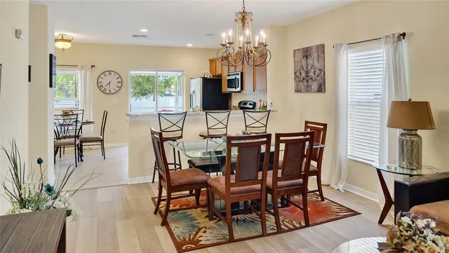a view of a dining room with furniture and chandelier