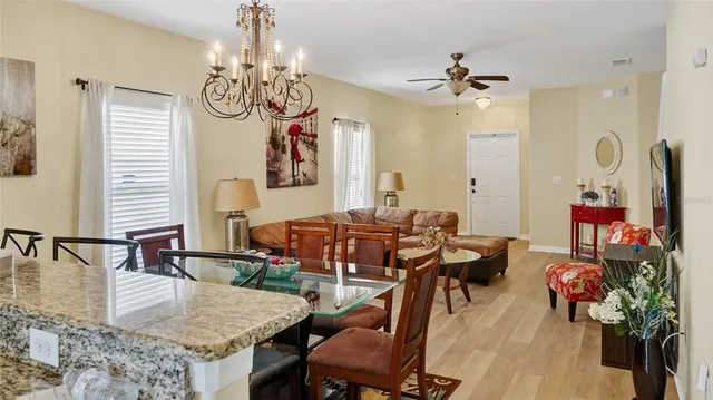 a view of a dining room with furniture and chandelier
