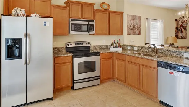 a kitchen with a sink stove and refrigerator