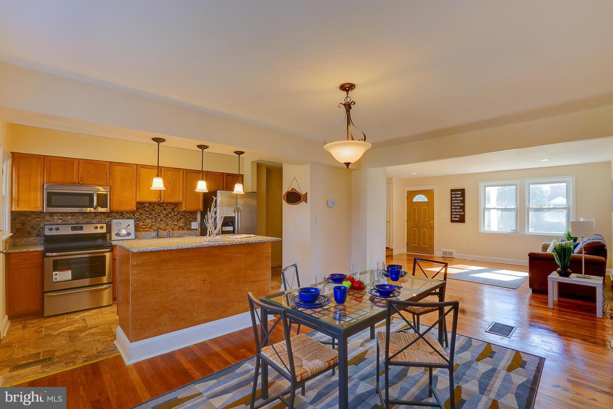 1434 Stonewood Road Baltimore, MD 21239 - Photo 11 of 28 a view of a dining room with furniture window and wooden floor