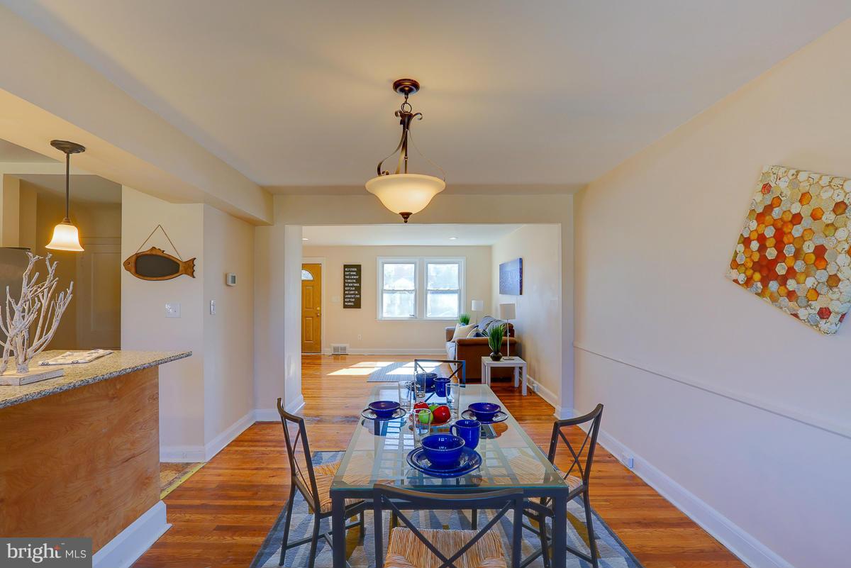 1434 Stonewood Road Baltimore, MD 21239 - Photo 13 of 28 a view of a dining room with furniture and chandelier