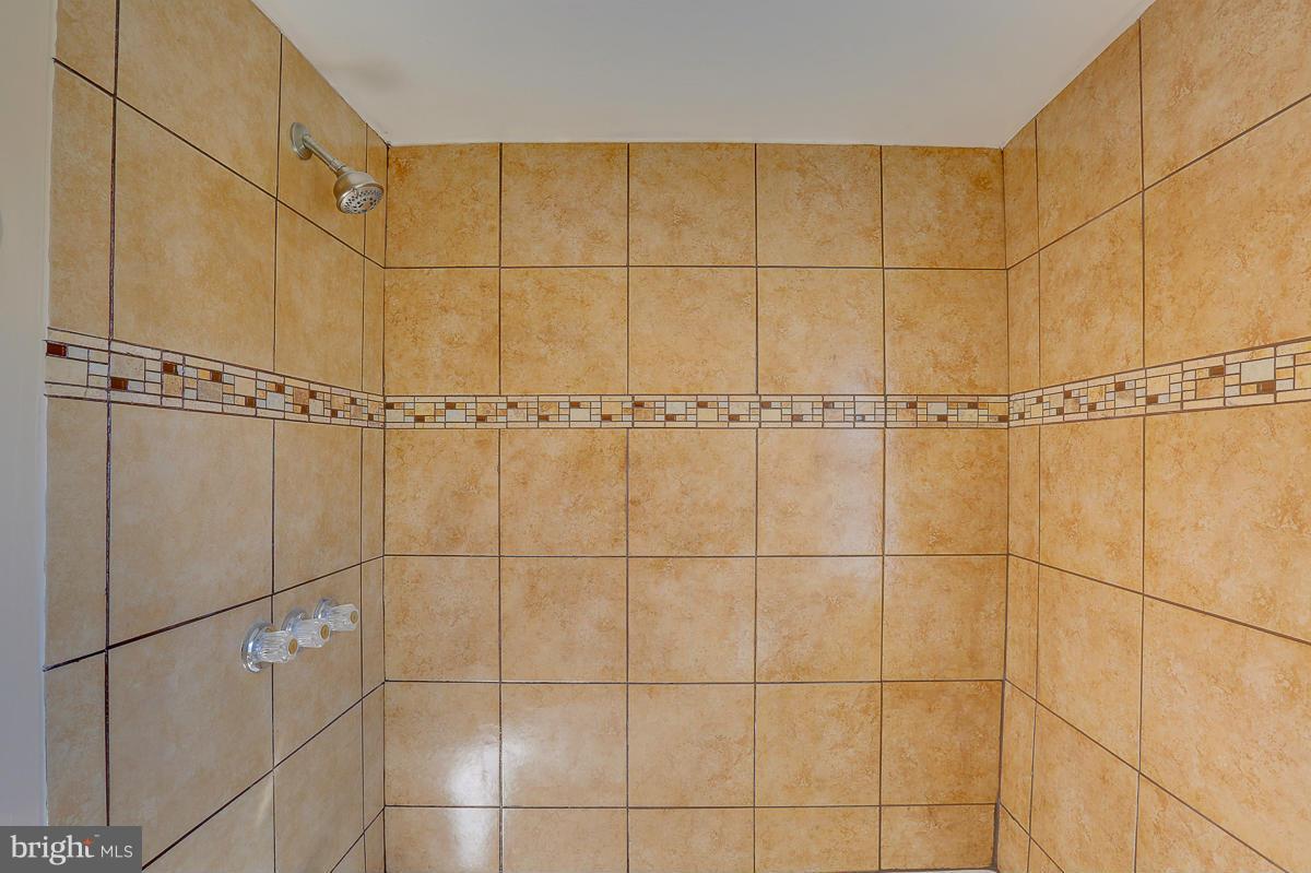 1434 Stonewood Road Baltimore, MD 21239 - Photo 24 of 28 a bathroom with a shower