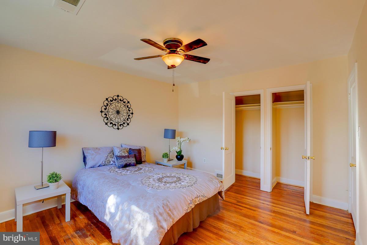 1434 Stonewood Road Baltimore, MD 21239 - Photo 26 of 28 a bedroom with a bed and wooden floor