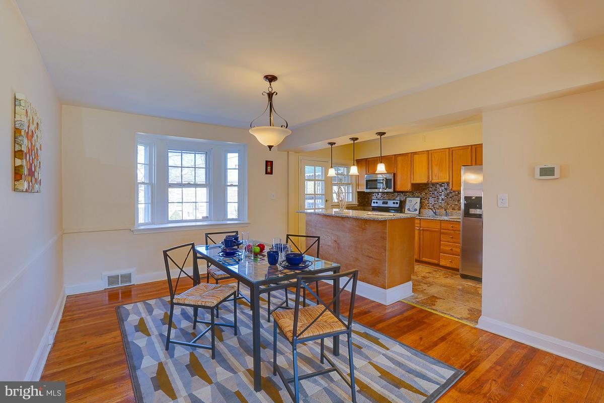 1434 Stonewood Road Baltimore, MD 21239 - Photo 10 of 28 a view of a dining room with furniture and chandelier