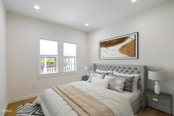 a bedroom with a bed and a painting on the wall