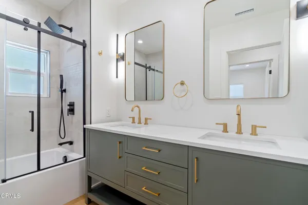 a bathroom with a double vanity sink mirror and double